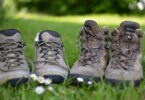 Two pairs of hiking boots on the grass