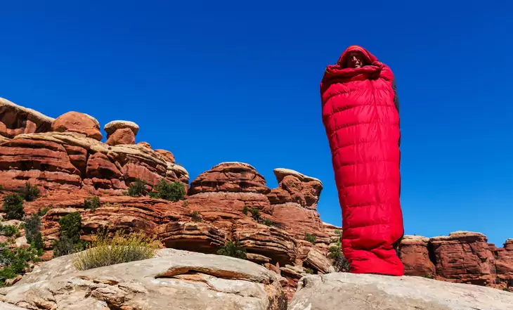 Man in a sleeping bag in the canyon