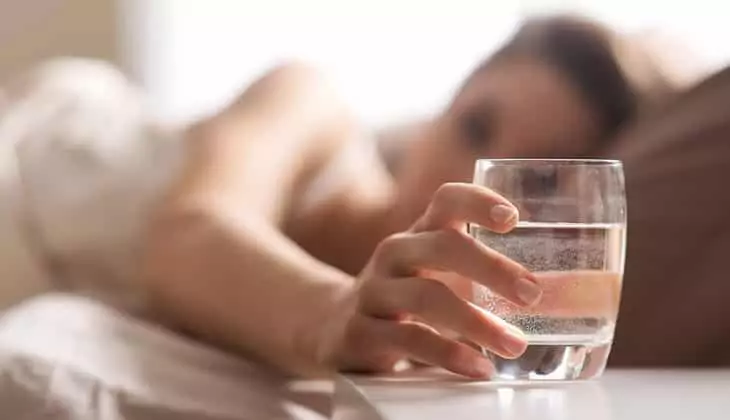 Woman getting hydrated before bedtime