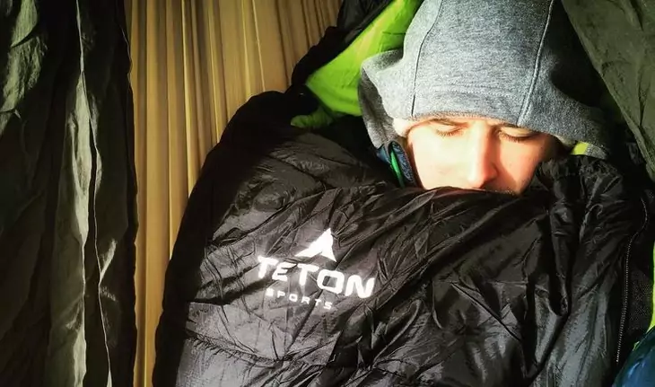 Man sleeping very well in a Teton Sports sleeping bag inside of a tent