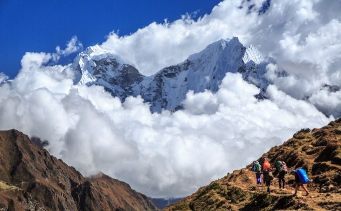 Hikers climbing a high mountain