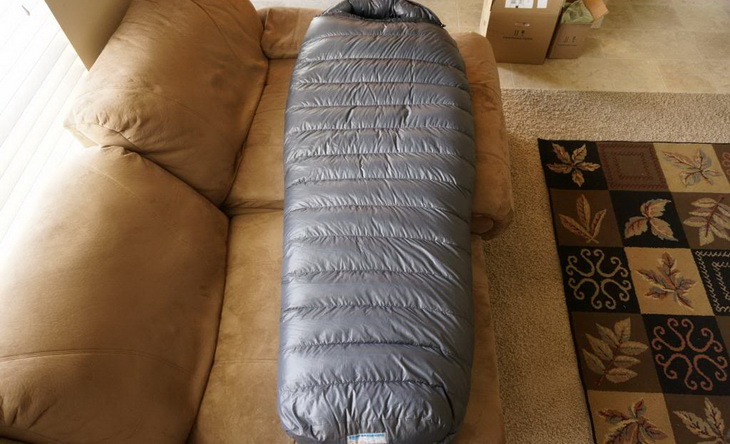 Western Mountaineering Sequoia sleeping bag in a house on the couch