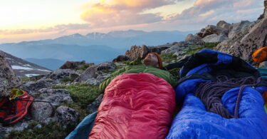 Man in a sleeping bag looking at the beautiful sky