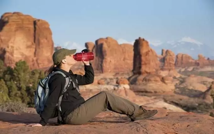 A hiker drinking water