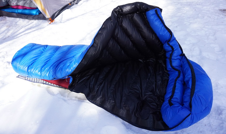 Western Mountaineering sleeping bag outside of a tent on the snow
