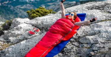 A woman sitting in the Nemo-Fusion-Hybrid sleeping bag
