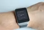 A man wearing Android Wear Smartwatch on his hand