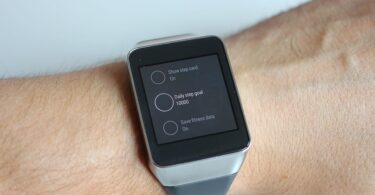 A man wearing Android Wear Smartwatch on his hand