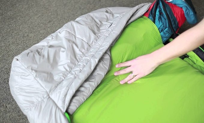 Image showing a woman with her hand on the Nemo Mezzo Loft Duo Synthetic Sleeping Bag