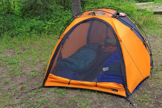 range tent outdoors with two sleeping bags
