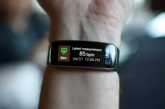 A person wearing activity tracker on left hand