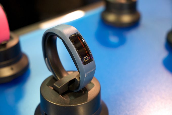 A blue waterproof activity tracker in a store