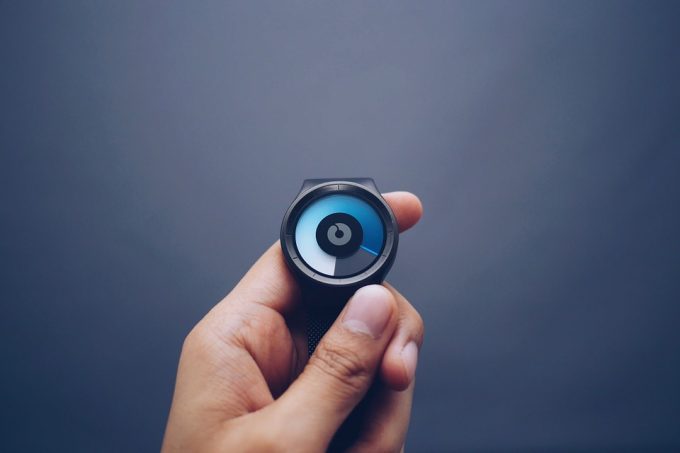 A person showing a black and blue fitness watch