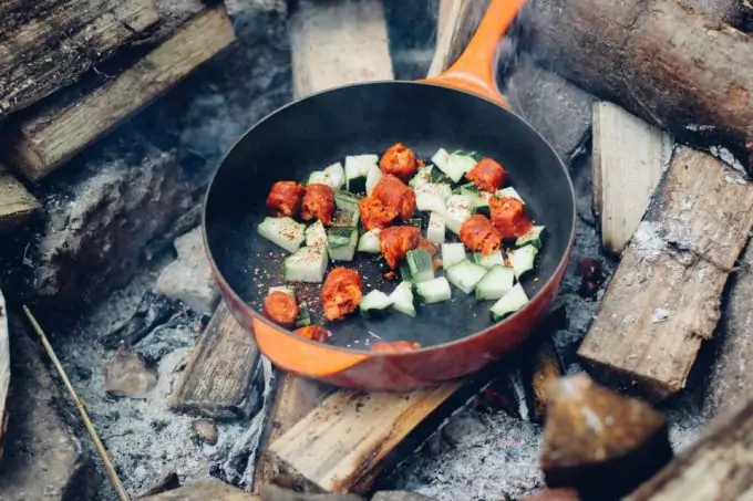 Food being cooked in a pan outdoors