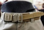 Brown tactical belt attached to a pair of pants in a store
