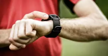 Image showing a runner looking at his fitness watch