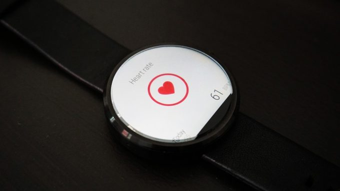 A heart rate smartwatch lying on black table