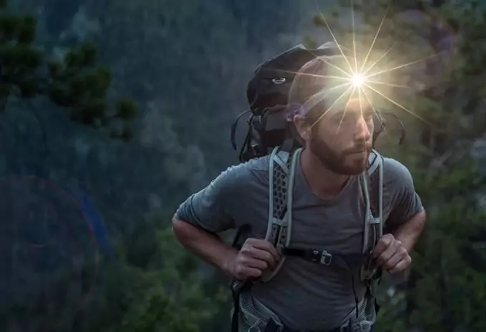 backpacker wearing a headlamp