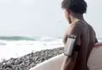 surfer going into sea with wallet