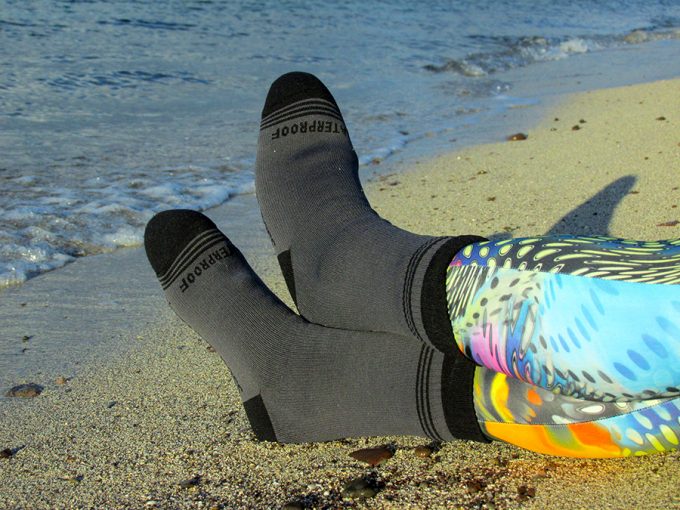 laying on beach sand with waterproof socks