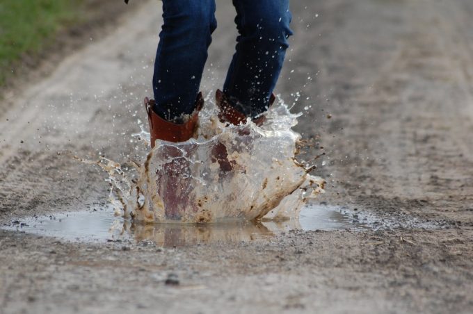 stepping into pond with waterproof socks