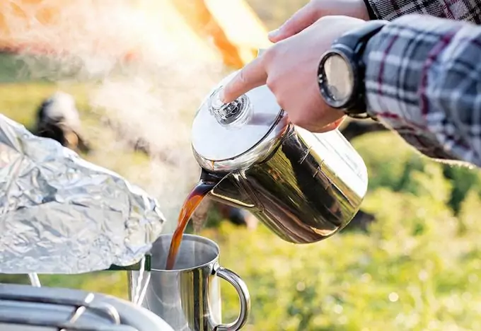 guy pouring hot coffee into cup