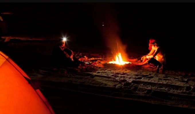 sitting by the fire with headlamps