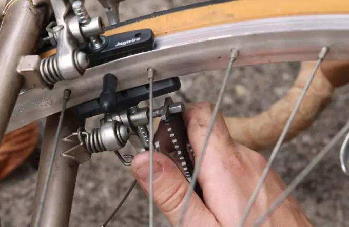 using multitool to repair bike
