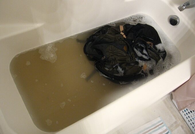 washing backpack in a tub