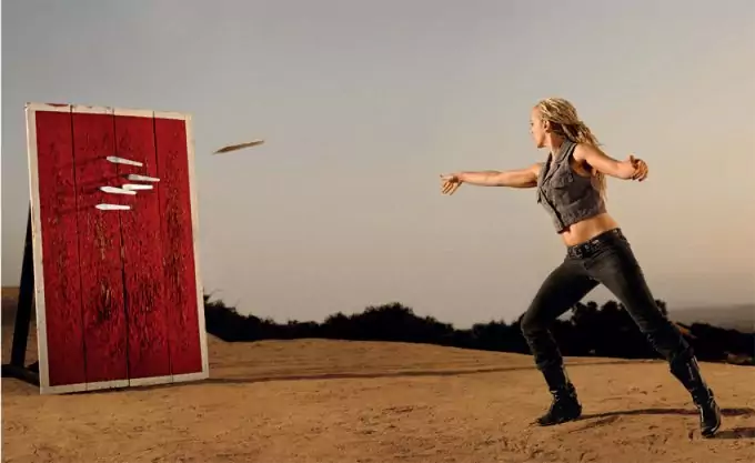 woman throwing knives