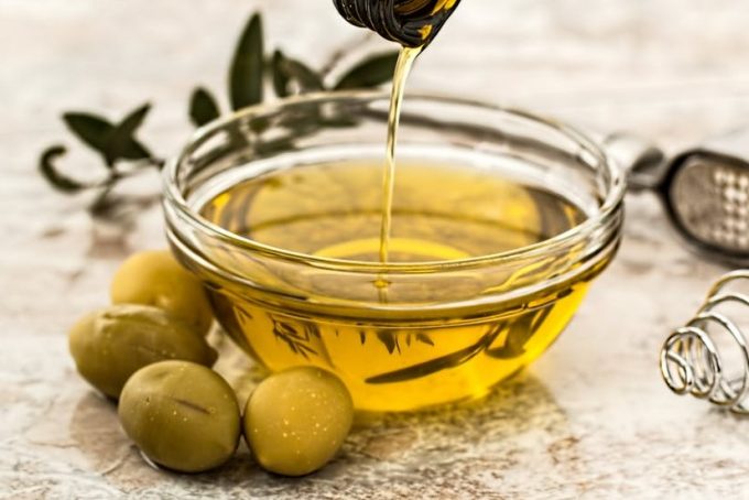 pouring olive oil in bowl