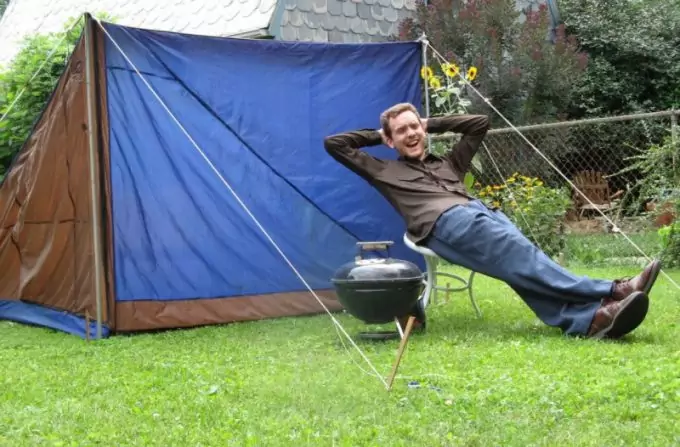 man enjoying near his diy tent